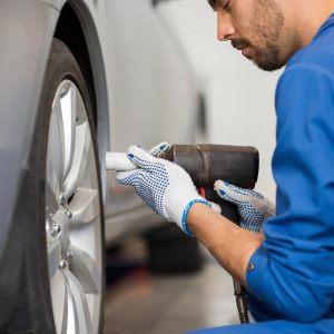 mechanic-with-screwdriver-changing-car-tire-P9CWJFG-rb7tzm5ro8kup1m45rx8jz3r4g8if3nv2rokw9muuw